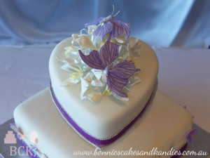 The heart shaped top tier was angled with the point almost touching the square shaped bottom tier, and the back of the heart raised  |  Bonnie's Cakes & Kandies, Gympie.
