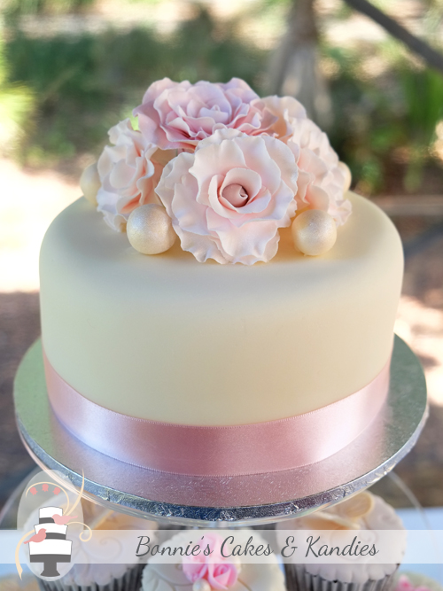 A posy of frilled rose-like fantasy flowers and edible pearls decorated the cutting cake  |  Bonnie's Cakes & Kandies 