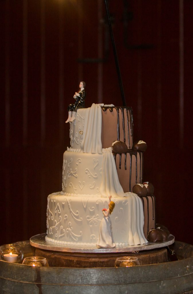Wedding cake by Bonnies Cakes and Kandies with chocolate drips and a traditional white fondant decoration for a half and half design.