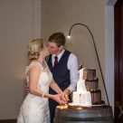 Bride and Groom kissing as they cut their gluten free wedding cake by Bonnies Cakes and Kandies